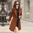 The vintage windbreaker pulls in knee-length tweed coat