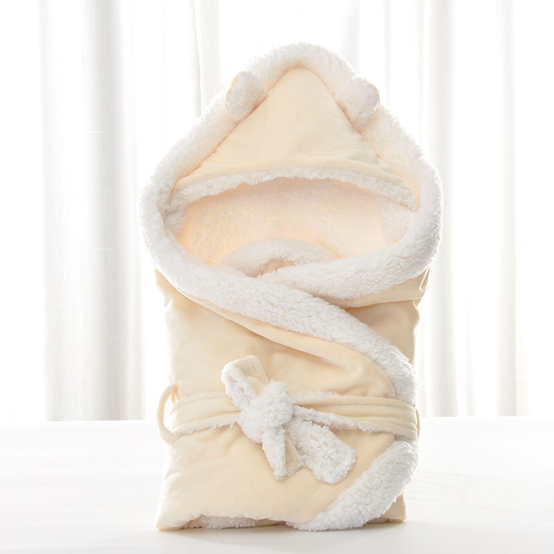 Newborn baby being hugged and swaddled